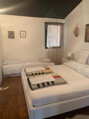 a bedroom with two beds and a window at Apartments Peace&Love in Baška