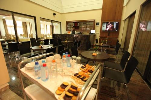 a restaurant with a table with food and drinks at Hotel Kratis in Kratovo