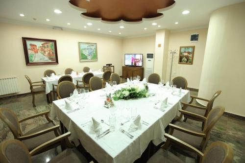 a dining room with a large table and chairs at Hotel Kratis in Kratovo