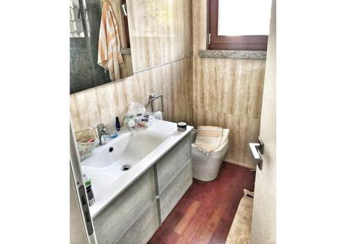 a bathroom with a sink and a mirror at Villa Antonella in Villasimius