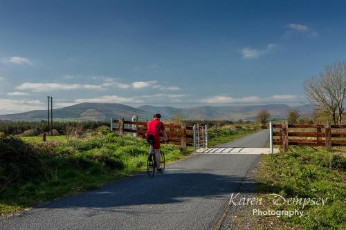 a man riding a bike down a road at Coolcormack Stud B&B in Waterford