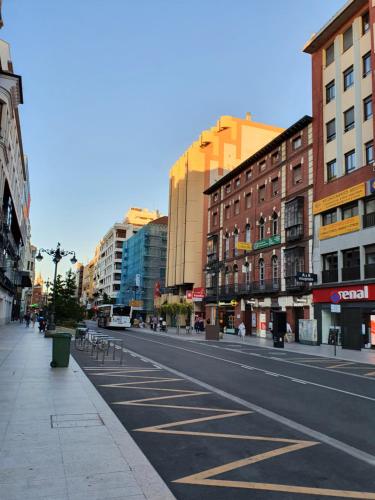 an empty street in a city with buildings at Ordoño II Suites con Aire Acondicionado y Wifi in León