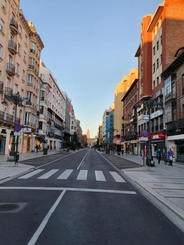 an empty street in a city with buildings at Ordoño II Suites con Aire Acondicionado y Wifi in León