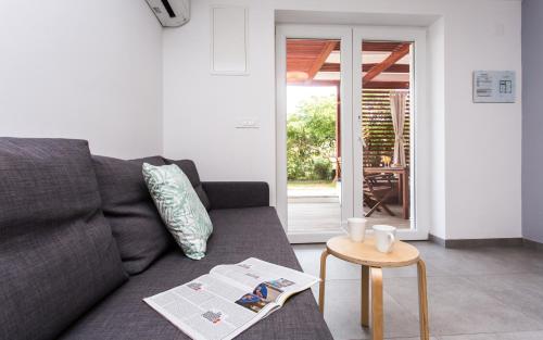 a living room with a couch and a table at Happy Apartments Baška in Baška