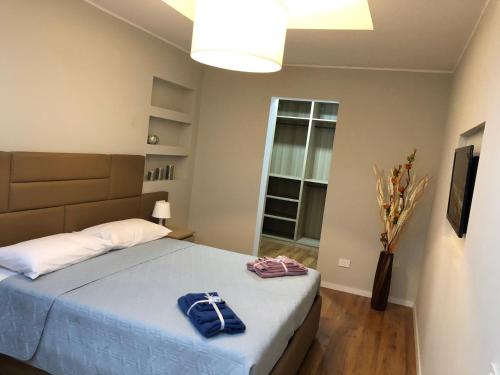 a bedroom with a bed with two towels on it at Zeroventiquattro Union Apartment in Grosseto