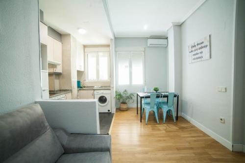 a living room with a couch and a table at Apartments Madrid Principe in Madrid