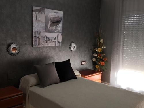a bedroom with a bed and a window at Villa Tito in Cunit