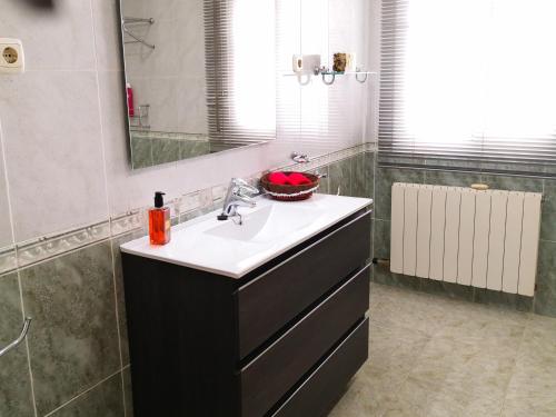 a bathroom with a sink and a mirror at Villa Tito in Cunit