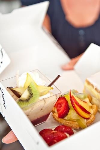 a box with a sandwich and fruit on a table at Laagers Hotel Garni in Samedan
