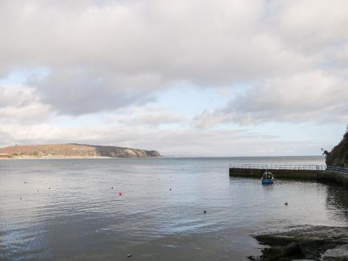 a boat is docked at a dock on a body of water at One Dolfor in Pwllheli