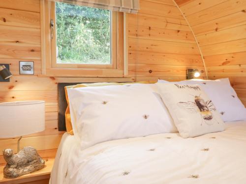 a bedroom with a bed in a log cabin at The Rhiw in Newtown