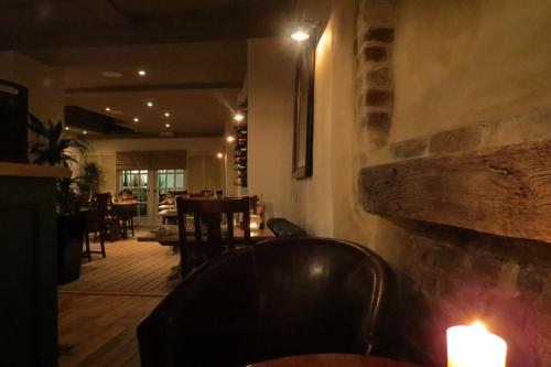 a restaurant with a table and chairs and candles at The Kings Head Hotel in Ross on Wye