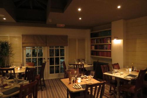 a restaurant with tables and chairs in a room at The Kings Head Hotel in Ross on Wye