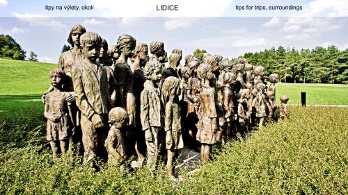 a statue of a group of people in a field at Guest House Prague Airport in Prague