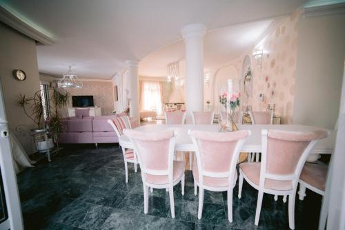 a dining room with a white table and chairs at Fruška Gora Klub Krstašice in Irig