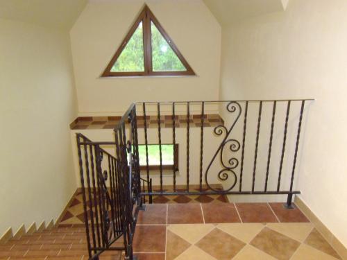 a stairway with a cross and a window at Willa Pawlikowskich in Poronin