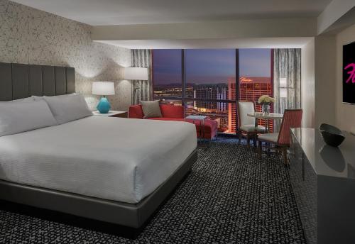 a hotel room with a bed and a view of a city at Flamingo Las Vegas Hotel & Casino in Las Vegas