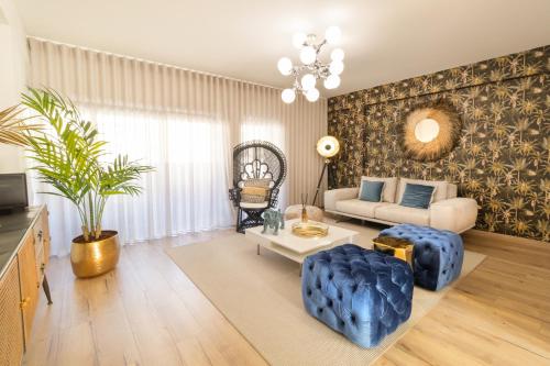 a living room with a couch and a table at Barra Apartament Design in Gafanha da Nazaré