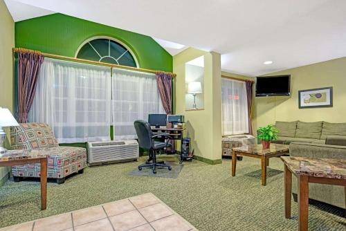 a living room with a couch and a desk at Microtel Inn and Suites - Inver Grove Heights in Inver Grove Heights