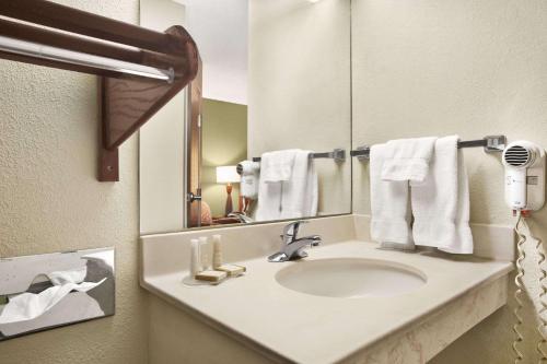 a bathroom with a sink and a mirror at Baymont by Wyndham Evansville North/Haubstadt in Haubstadt