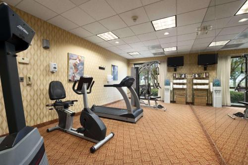 a gym with treadmills and exercise bikes in a room at Ramada by Wyndham Suites Orlando Airport- Free Airport Shuttle in Orlando