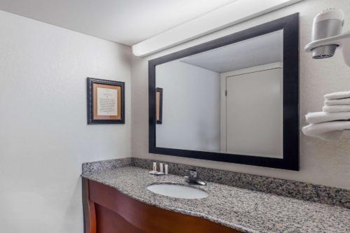 a bathroom with a sink and a large mirror at Baymont by Wyndham Pigeon Forge near Island Drive in Pigeon Forge