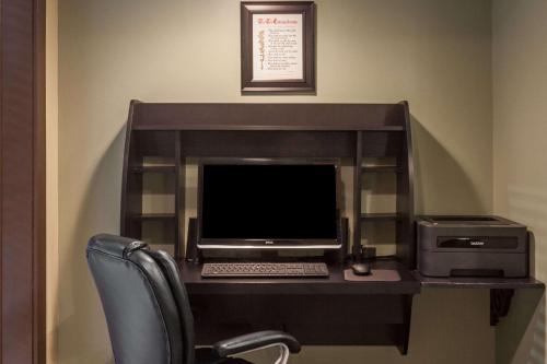 a desk with a computer monitor and a printer at Baymont by Wyndham Pigeon Forge near Island Drive in Pigeon Forge