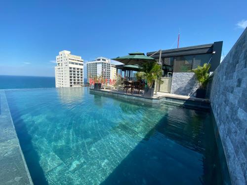 a swimming pool on the roof of a building at Santa Luxury Hotel in Da Nang