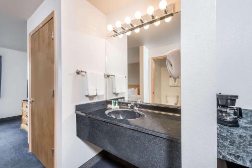 a bathroom with a sink and a mirror at Baymont by Wyndham Indianapolis Northeast in Indianapolis