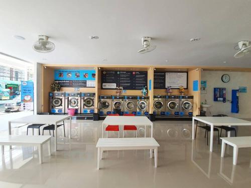 a room with tables and washing machines in a store at Klongrien Boutique Hotel in Hat Yai