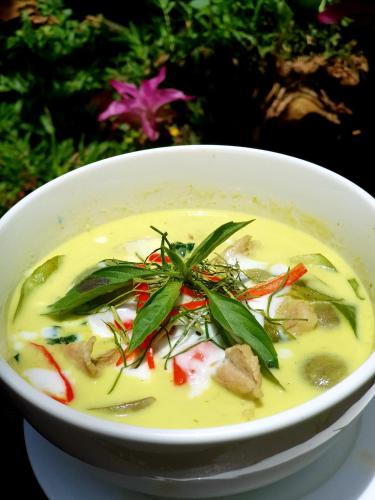a white bowl of soup with vegetables in it at Our Jungle House in Khao Sok