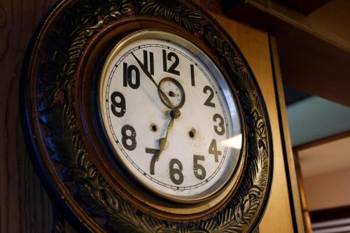 a clock is hanging on a wall at Seikiro Ryokan Historical Museum Hotel in Miyazu