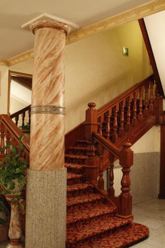 a spiral staircase in a house with a column at Hotel Genio in Rome