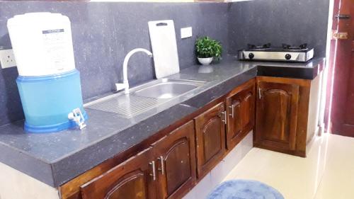 a kitchen with a sink and a counter top at The Max Villa in Negombo