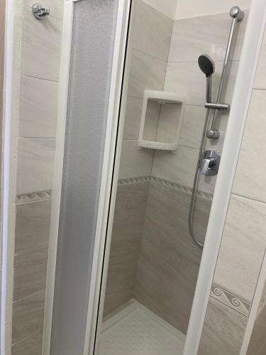 a shower with a glass door in a bathroom at Stabilimento Balneare Città Giardino - Casa Vacanza in Viareggio