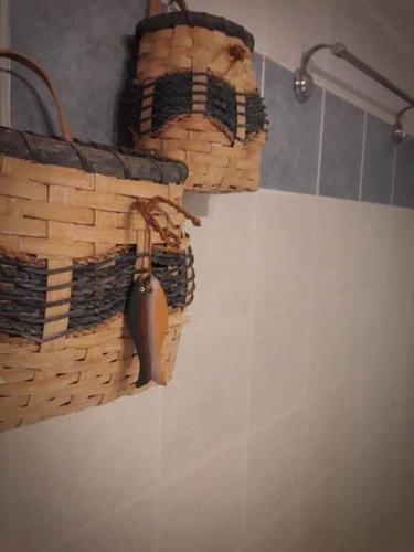 two baskets hanging on the side of a refrigerator at On the beach in Koutsounari
