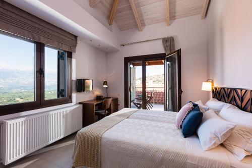 a bedroom with a bed and a large window at Villa Galanis in Kalamitsi Amygdali