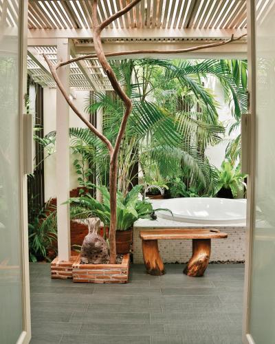a bathroom with a bath tub and a tree at Shantaa Resort, Kohkood in Ko Kood
