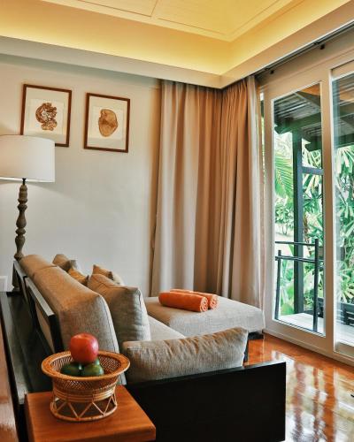a living room with a couch and a table at Shantaa Resort, Kohkood in Ko Kood