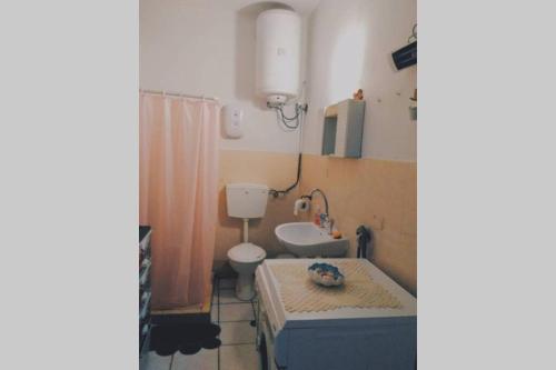a bathroom with a dog laying on a mattress in a tub at Iliana's courtyard in Evdilos