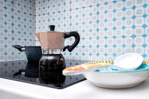 a coffee maker on a counter next to a bowl at Il Nido Casa Vacanze in Atrani