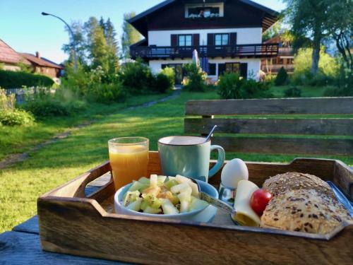 a tray of food with bread and a cup of orange juice at Drachenfels in Oberstdorf