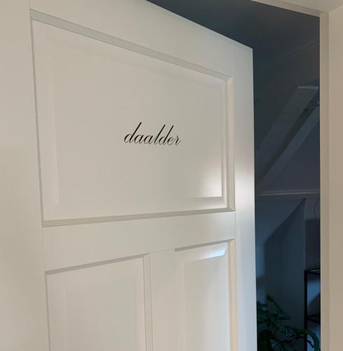 a white door with the word laundry written on it at Logement de Spaerpot in Middelburg