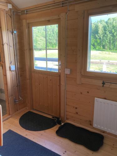 a small room with a window and two mats at Asplunda Gård,Kolmården, stuga nr 4 in Kolmården