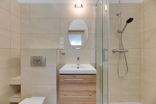 a bathroom with a sink and a shower at Grand Apartments - Studio Apartment 50 m from Monte Cassino in Sopot