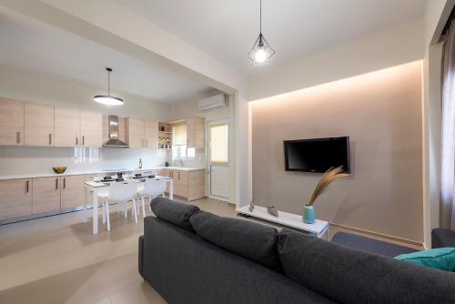 a living room with a couch and a kitchen at Fofi’s Elegant Home in Kos Town