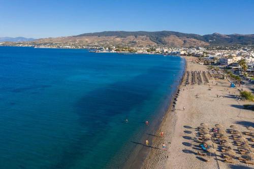 an aerial view of a beach with chairs and umbrellas at Fofi’s Elegant Home in Kos Town