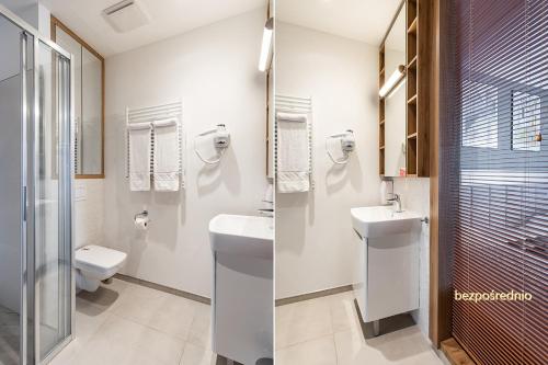 a bathroom with a toilet and a sink at Apartament w Warszawie dedykowany parking podziemny w cenie, WiFi, blisko centrum New apartment in Warsaw finished to a high specification fitted out to a high standard on the 7th floor, WiFi, underground parking price included in Warsaw