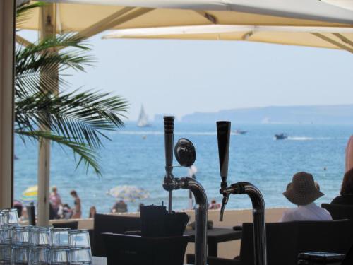 a view of the beach from a restaurant with umbrellas at Sandbanks Hotel in Poole