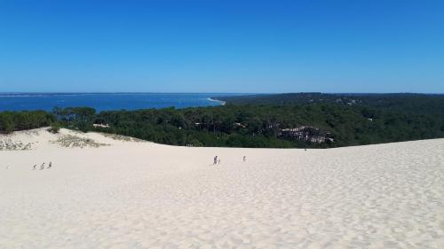 a group of people standing on top of a white beach at Mimosas in Andernos-les-Bains